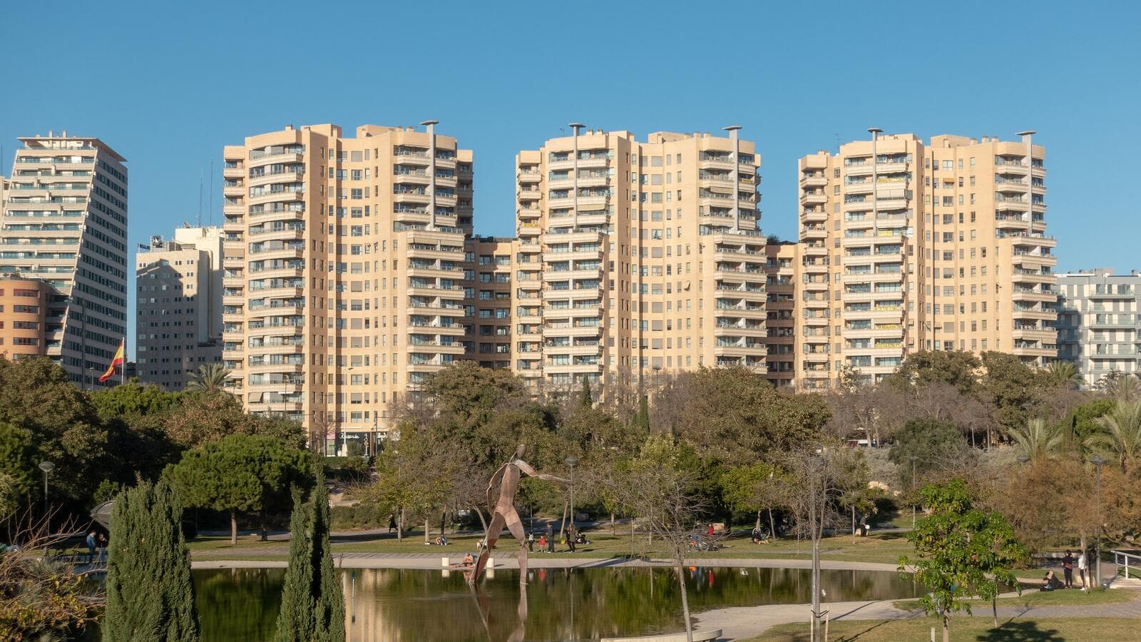 Apartment blocks along the Turia gardens in Valencia, seen across the park's lake.